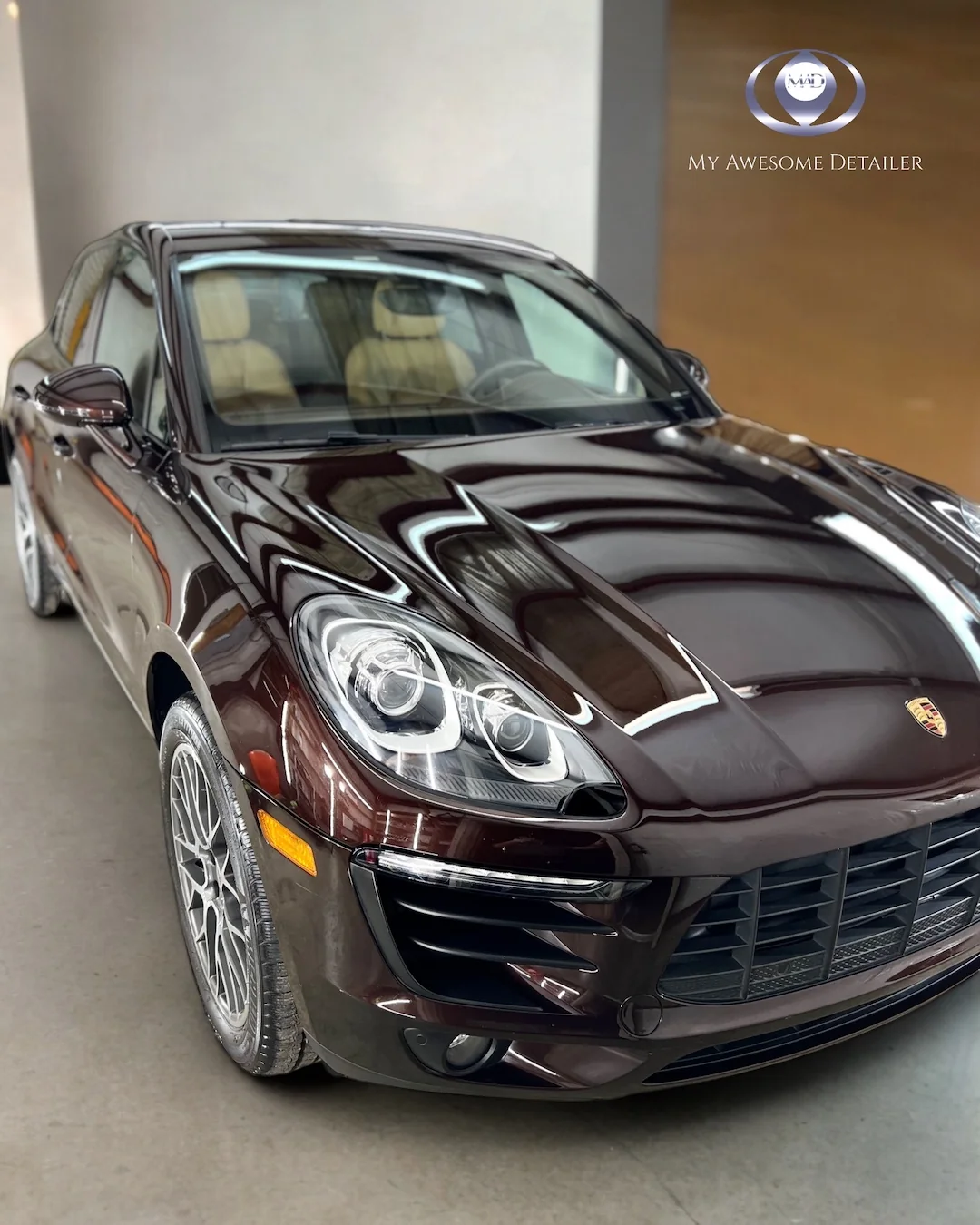 Brown Porsche Macan in shop