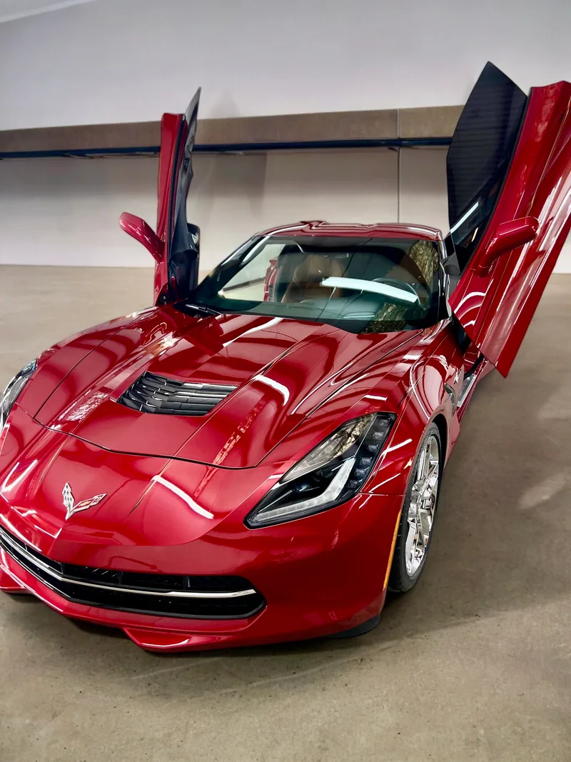 Red Corvette C7 with lambo doors in shop