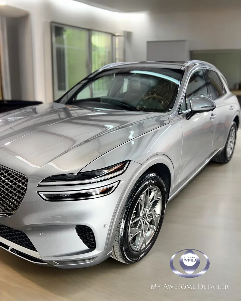 Silver Genesis GV70 front close-up in shop